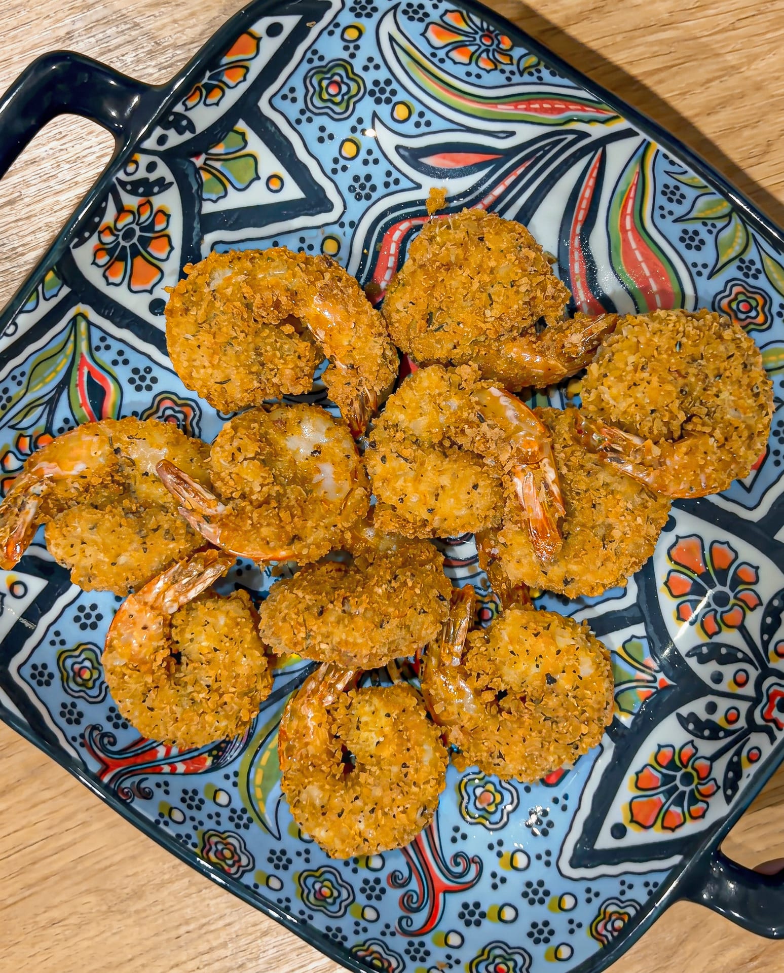 Crumbed prawns on a patterned platter